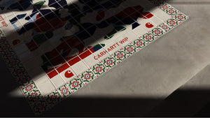 The image shows a tiled floor with a colorful abstract design in the center, bordered by decorative floral tiles and the text 'CARHARTT WIP' in red. Shadows partially cover the tiles, adding depth to the scene.